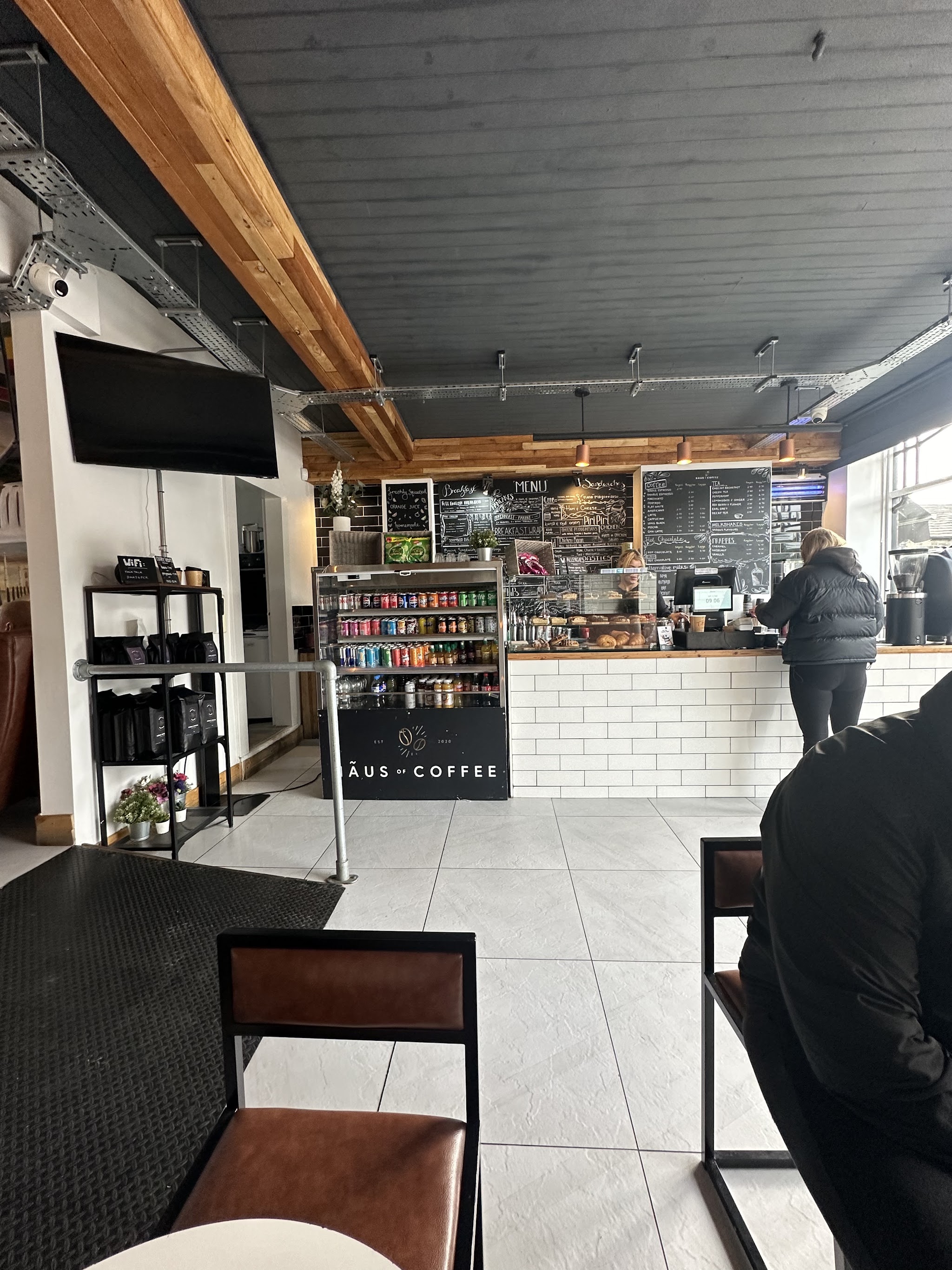 Inside Hãus of Coffee, looking towards the counter and handwritten menu